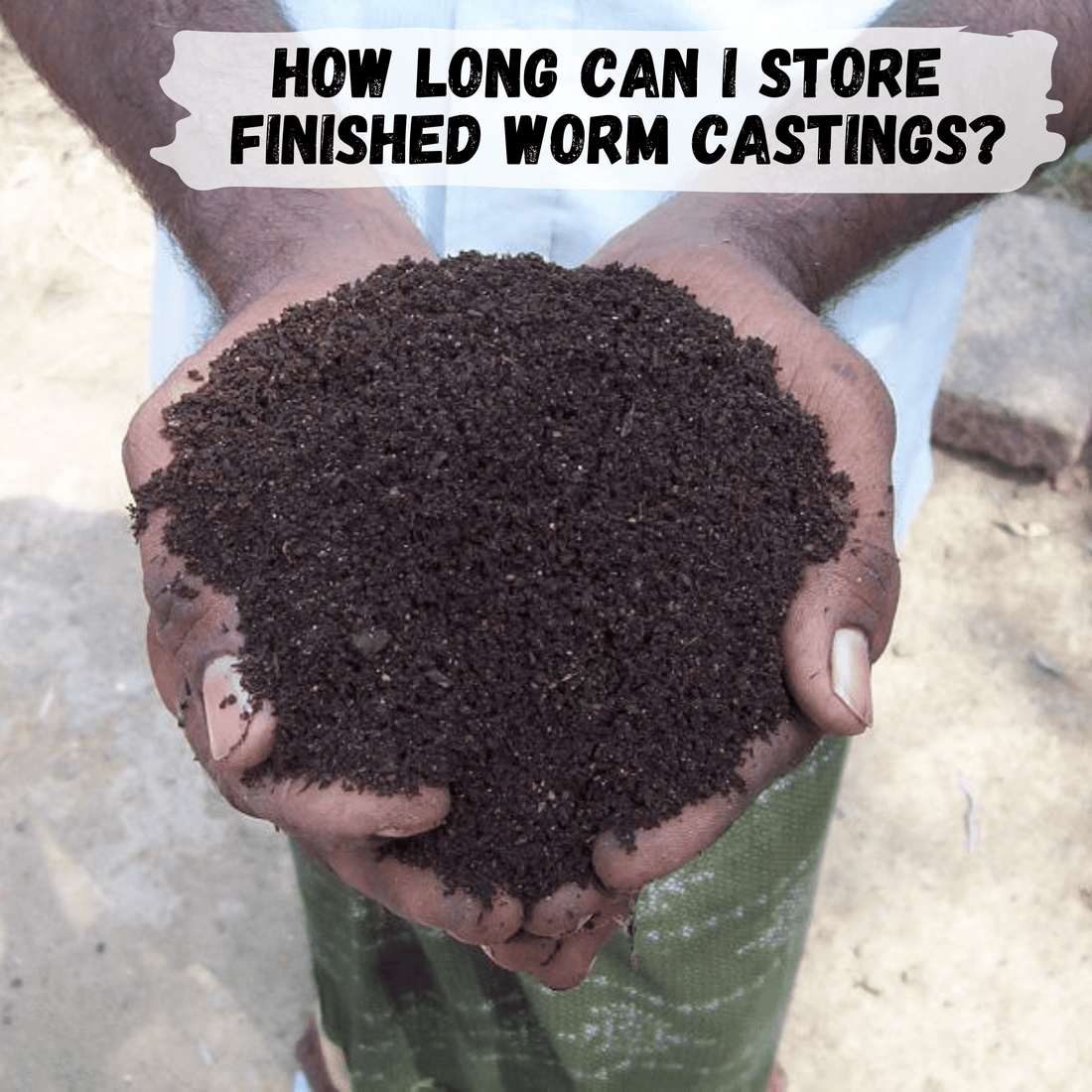 close up of hands holding finished worm castings that look like rich, fresh soil.